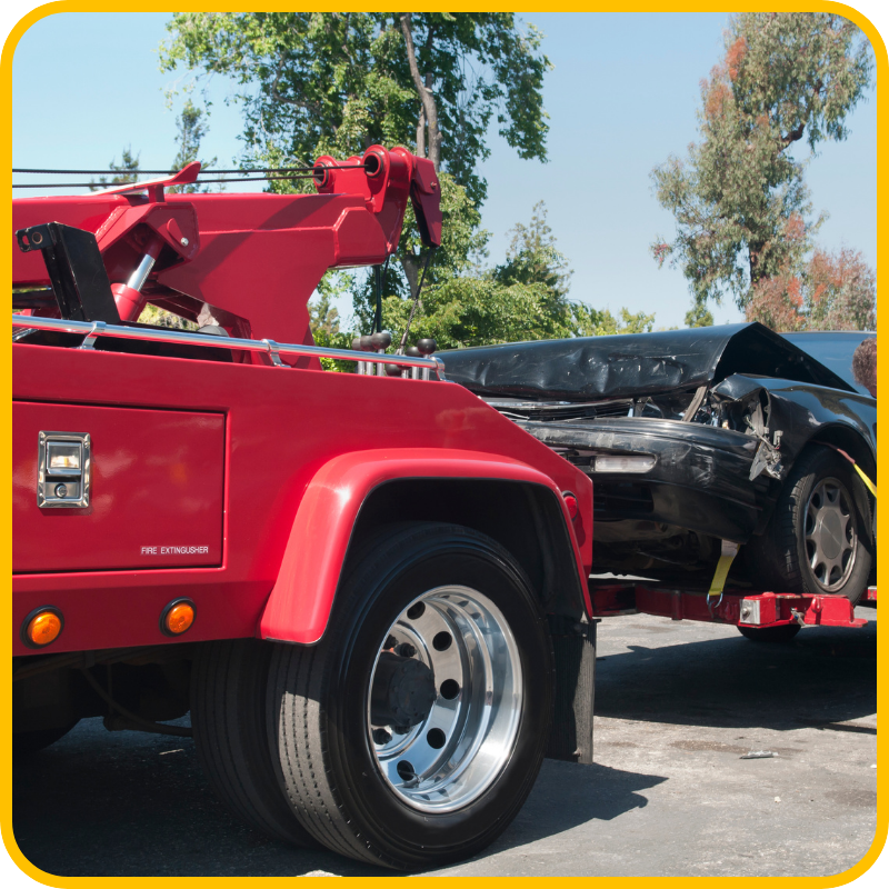 wrecked car being towed